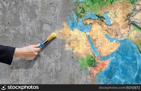 Safe our planet. Close up of business person hand painting Earth planet. Elements of this image are furnished by NASA