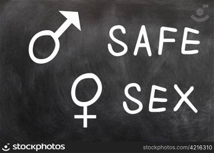 Safe Sex with gender symbols written with chalk on a blackboard
