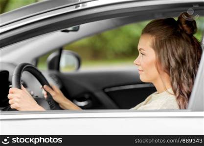 safety and people concept - young woman or female driver driving car in city. woman or female driver driving car in city
