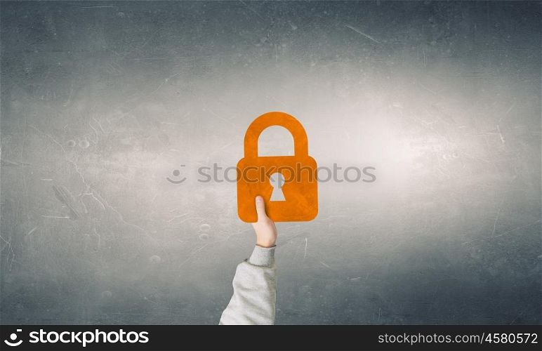 Safety and protection concept. Many hands of business people holding locker sign