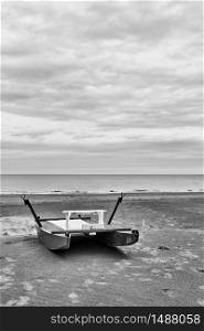 Safety boat - catamaran by the sea on empty beach in Rimini at off-season, Italy - Minimalistic landscape, black and white photography