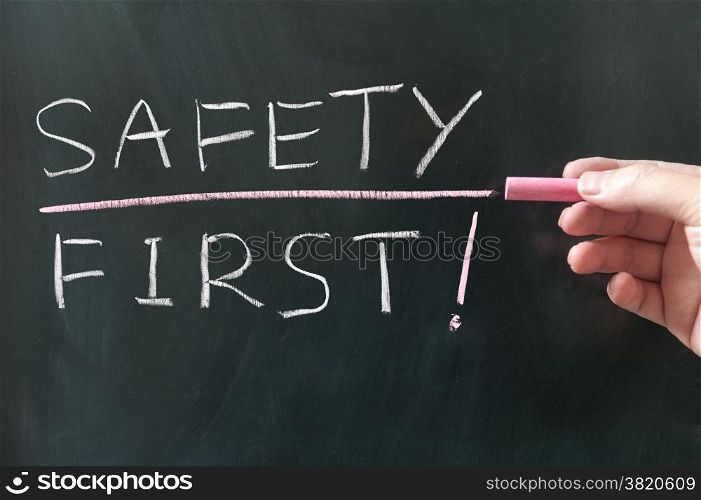 Safety first words written on blackboard