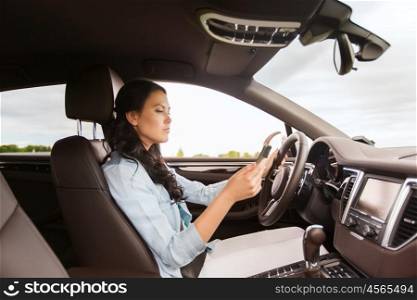 safety, road trip, technology, travel and people concept - woman driving car with smarhphone