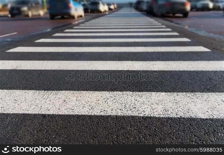 safety, traffic laws, highway code and road sign concept - close up of pedestrian crosswalk on city car parking
