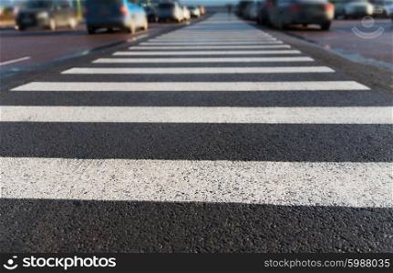 safety, traffic laws, highway code and road sign concept - close up of pedestrian crosswalk on city car parking