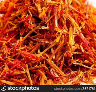 Saffron treads in pile, isolated on white, shallow dof
