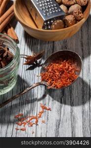 saffron with various spices on wooden background - anise, cinnamon, ginger, nutmeg,