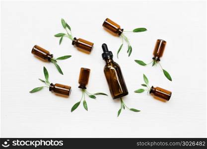 Sage essential oil with sage leaves on white blackground.. Natural sage essential oil with sage leaves on white blackground.