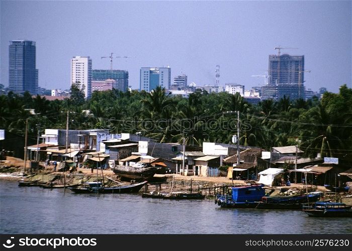 Saigon River contrasts with hi-rises in background, Vietnam