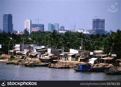 Saigon River contrasts with hi-rises in background, Vietnam