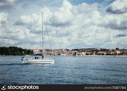 Sail boats and clear blue water in a Croatian bay, golden cape