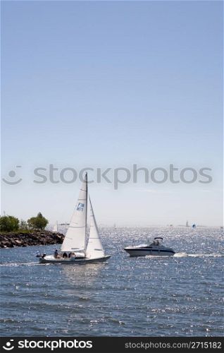 Sailboat and motorboat very close of each other