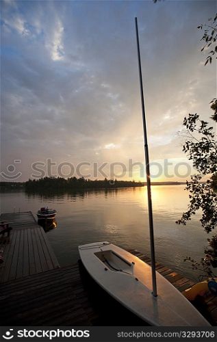 Sailboat at the dock with the sunset in background at Lake of the Woods, Ontario