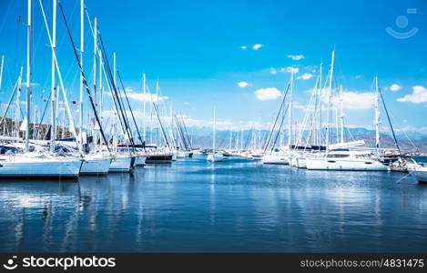 Sailboat harbor, many beautiful moored sail yachts in the sea port, modern water transport, summertime vacation, luxury lifestyle and wealth concept