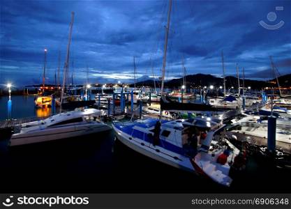 sailboat harbor, moored sail yachts in the sea port at twilight time