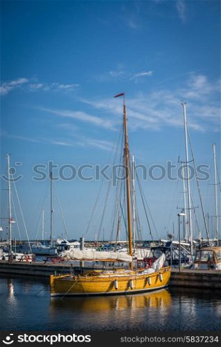 Sailboat in a marine harbor in the summertime