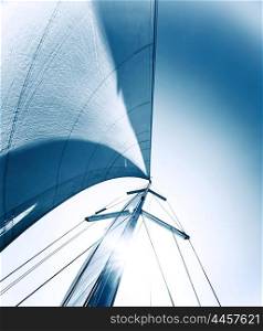 Sailboat in action, big white sail raised over blue clear sky, luxury leisure, summertime activities and extreme sport, boat parts with sun rays, sailing trip vacation, freedom concept