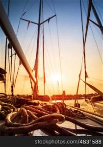Sailboat in sunset light, sail yacht detail, yachting sport, adventure in the sea, summer holidays, luxury water transport