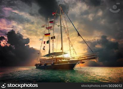 Sailboat in the sea and storm clouds. Sailing ship in sea. Sailing ship in sea