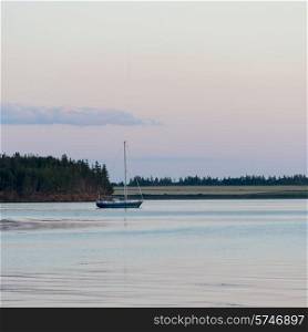 Sailboat in the sea at dusk, Spinnakers Landing, Summerside, Prince Edward Island, Canada
