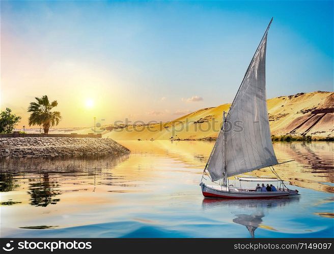 Sailboat on river Nile in Aswan at sunset, Egypt. Sunset and sailboat in Aswan