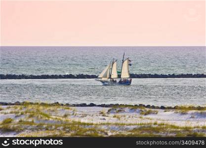 Sailboat sailing at the sunset sky