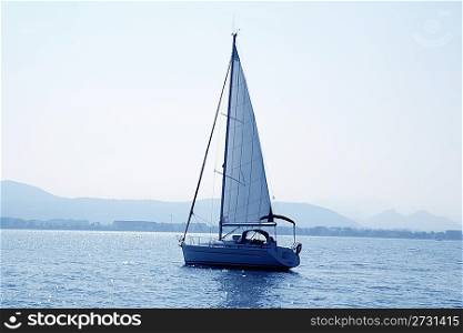 sailboat sailing in blue mediterranean sea mountain horizon Denia Spain