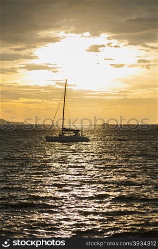 Sailboat sailing in the sea. sunlight reflecting off the sea