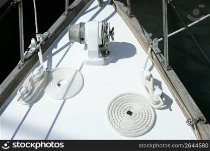 sailboat white bow with bollard and spiral rope moored on port
