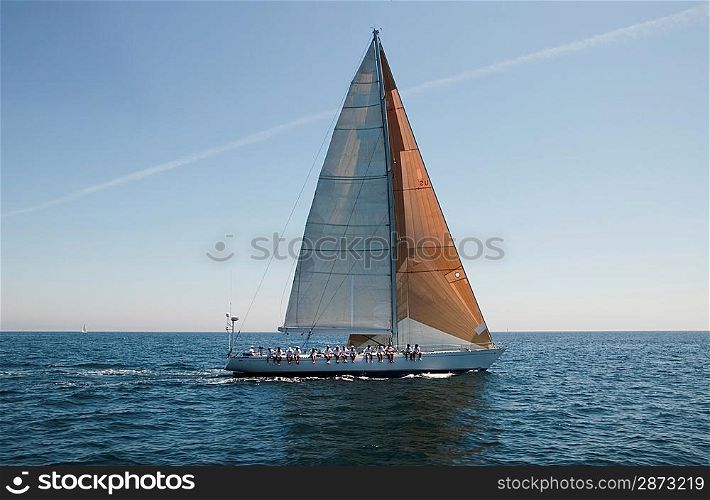 Sailboat with Crew Sitting on Side