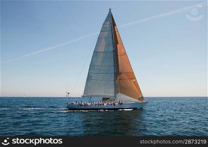 Sailboat with Crew Sitting on Side