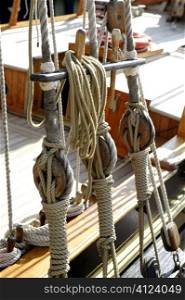 Sailboat wooden marine rigs and ropes. Nautical traditional tackle
