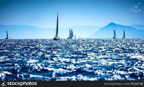 Sailboats in the sea, water racing, regatta in the Mediterranean sea, summer adventure, active summer travel, vacation and travels to Greece