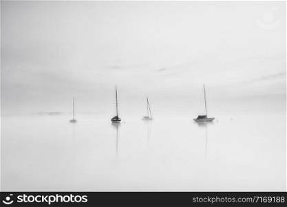 sailboats on lake Ammersee Bavaria Germany on a foggy day, black and white shot
