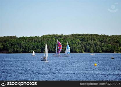 Sailboats on the blue water. summer day at lake