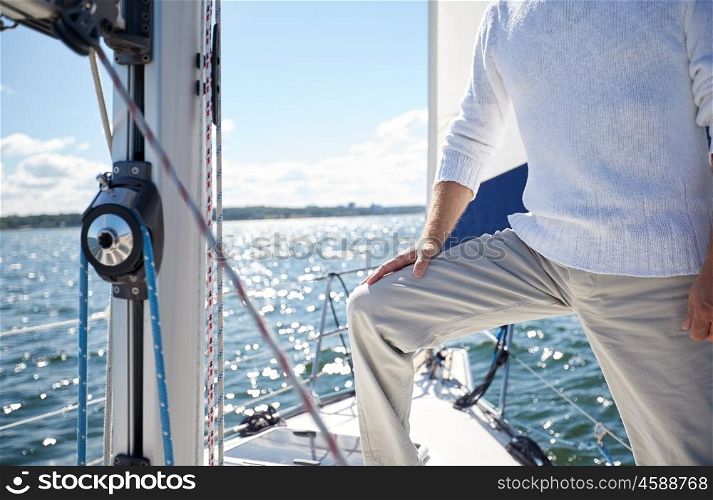 sailing, age, tourism, travel and people concept - close up of senior man on sail boat or yacht floating in sea