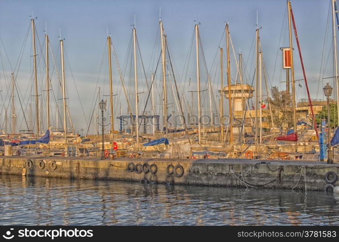 Sailing and engine boats moored in the harbour channel of Cervia in Northern Italy on the Adriatic Sea