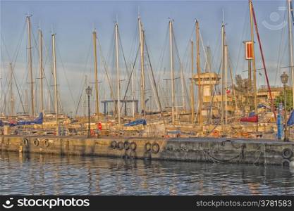 Sailing and engine boats moored in the harbour channel of Cervia in Northern Italy on the Adriatic Sea