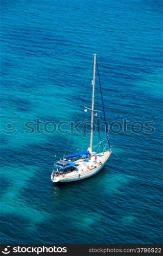 Sailing boat in blue water bay in Malta
