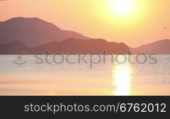 Sailing boat in the sea at sunrise