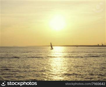 Sailing boat in the sunset of the Gulf of Finland. Sailing boat on the sea at sunset.