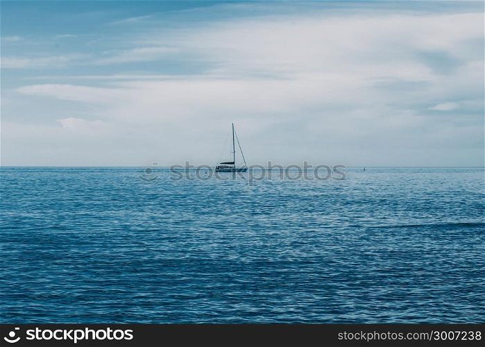 Sailing boat on Blue sea with heavy storm clouds. Sailing yacht race