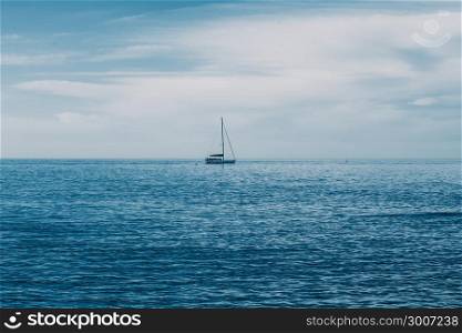 Sailing boat on Blue sea with heavy storm clouds. Sailing yacht race