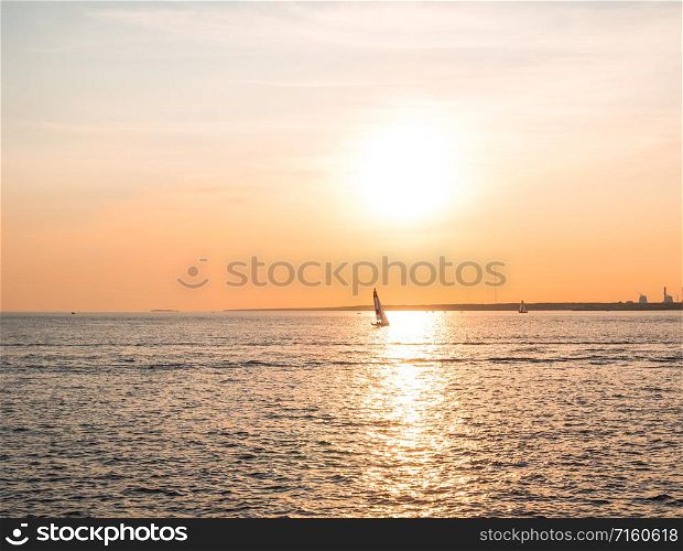 Sailing boat on the sea at sunset.. Sailing boat in the sunset of the Gulf of Finland