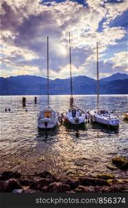 Sailing boats at the coast of a lake in Italy, Evening scenery