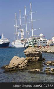 Sailing ships at a harbor, Mandraki Harbor, Rhodes, Dodecanese Islands, Greece