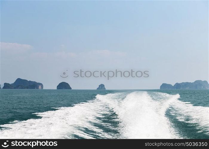 sailing, travel, tourism, seascape and nature concept - ocean and leaving boat trace on water. leaving boat trace on water