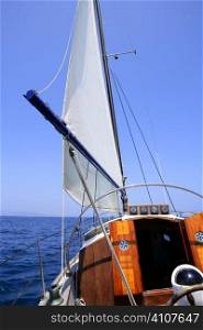 Sailing with an old sailboat over blue mediterranean summer sea