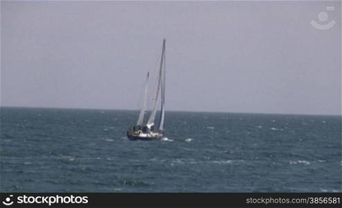 Sailing yacht in sea.