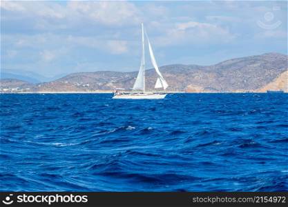 Sailing yacht on the background of the Mediterranean coast. Cloudy weather. Sailing Yacht in the Mediterranean Sea